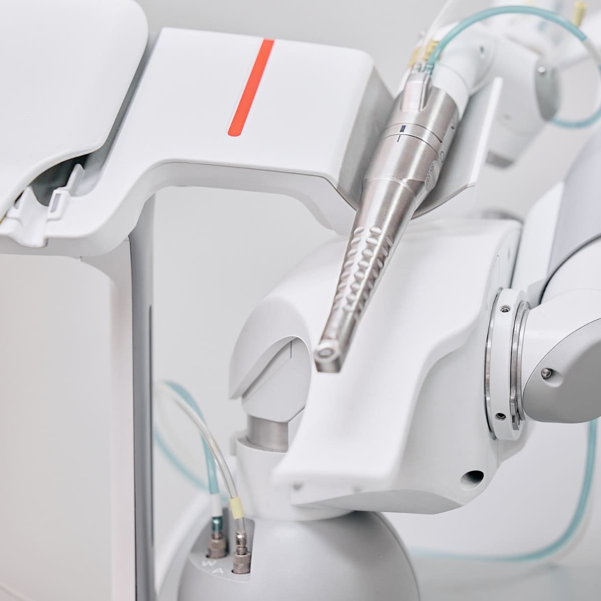 Close-up of advanced medical laser handpiece attached to aesthetic treatment device in clinical setting