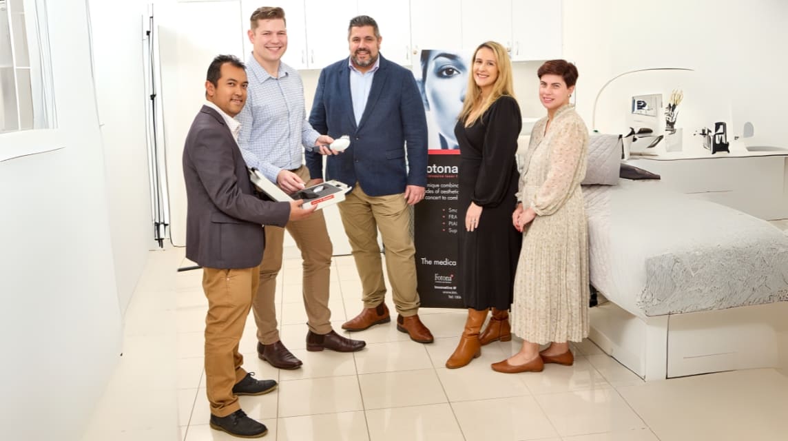 TRUSTED MEDICAL LASER SUPPLIER (1) Medical aesthetics team standing in modern clinic showcasing advanced laser device and treatment solutions banner